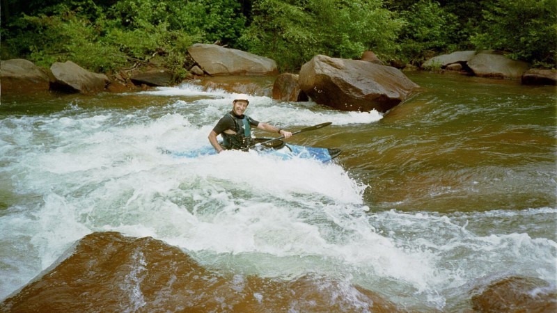 Harry Tutor surfing and grinning.