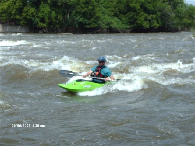 "Dave the Wave" enjoying a medium level surt - left channel below the dam