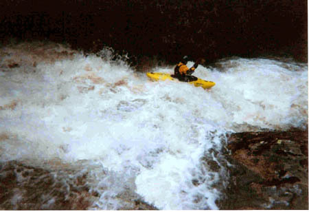 Chris runs a slide below the falls